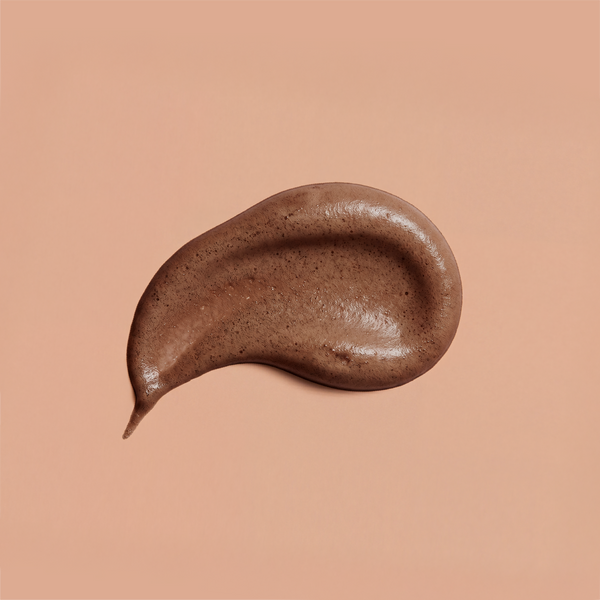 A swatch of brown frank body Firm + Glow Self Tan Mousse on a tan background.