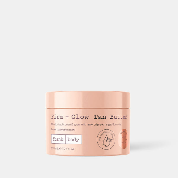 A peach-colored jar of Frank Body Firm + Glow Tan Butter on a light gray background.
