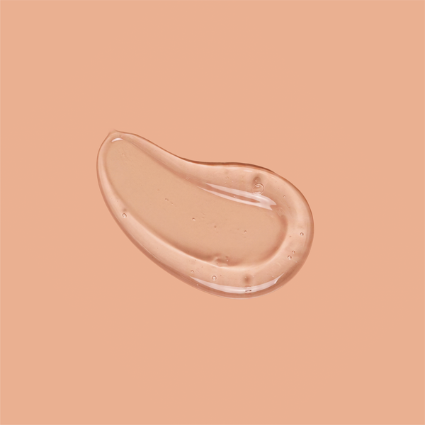 A swatch of clear frank body Firm + Glow Tanning Jelly on a tan background.