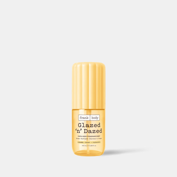 A 100ml bottle of frank body On-the-Go Glazed 'n' Dazed Hair & Body Fragrance Mist in caramel, cream and pistachio.