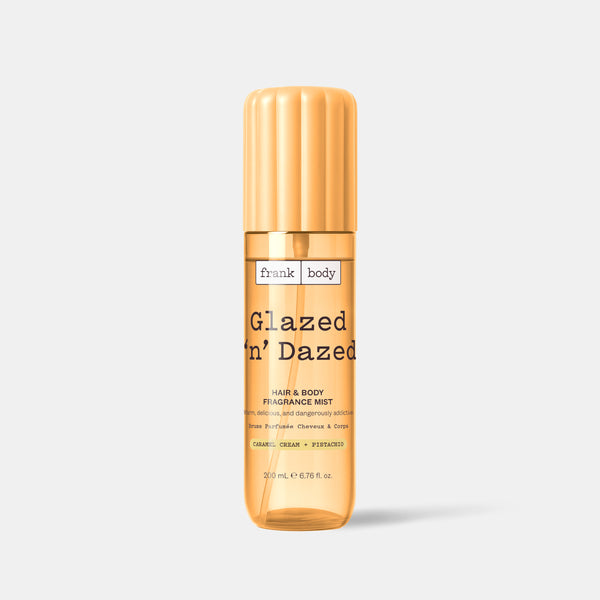 A yellow bottle of frank body Glazed 'n' Dazed Hair & Body Fragrance Mist in caramel, cream and pistachio, 200ml.