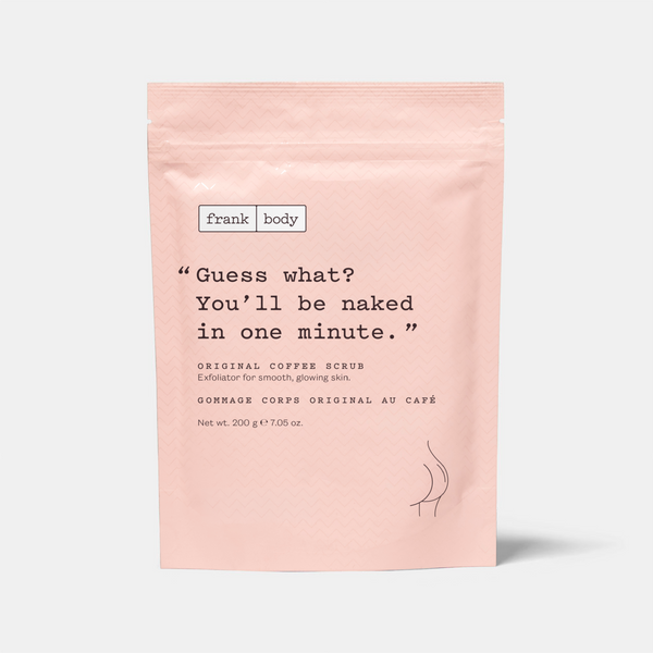 A light pink stand-up pouch of frank body Original Coffee Scrub with black text and a small black line drawing of bare midriff, photographed on a light gray background.