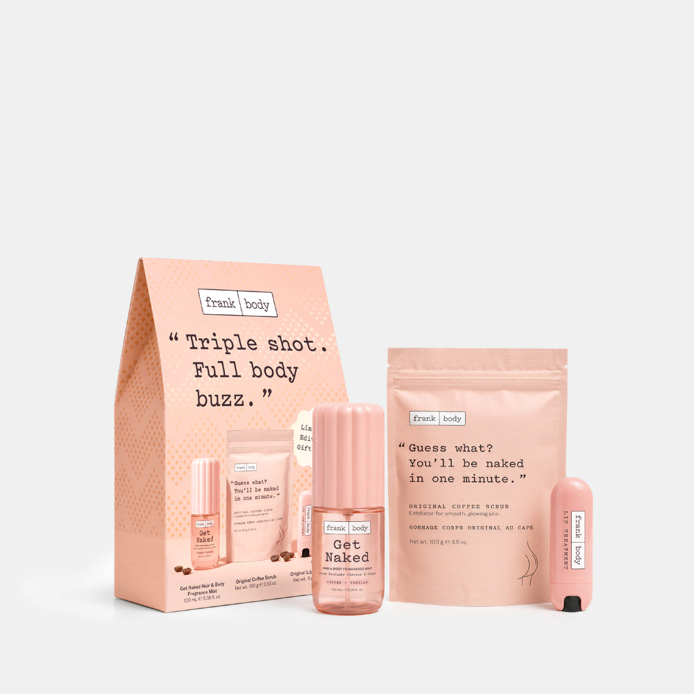 Frank Body triple shot detox kit featuring a peach-colored paper bag, a bottle of Get Naked tea, a pouch of Natural Coffee Bean + Green Tea, and two small pink lip balm tubes on a light gray background.