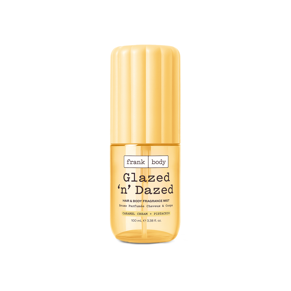 A yellow 100ml bottle of frank body Glazed 'n' Dazed Hair & Body Fragrance Mist in caramel, cream and pistachio.