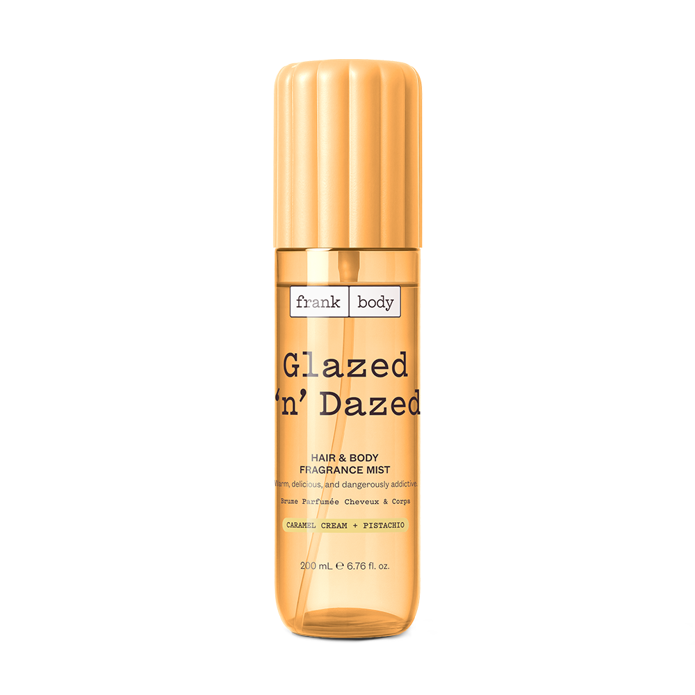 A yellow 200ml bottle of frank body Glazed 'n' Dazed Hair & Body Fragrance Mist in caramel, cream and pistachio.