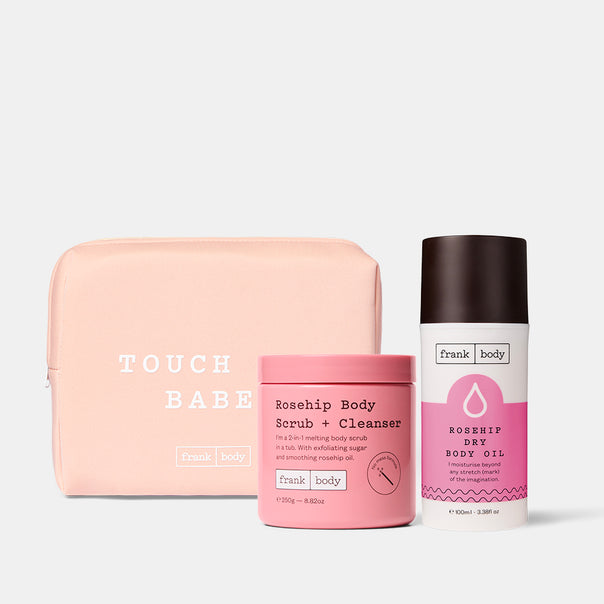 The frank body Grab My (Rose)Hips Kit: Rosehip Body Scrub + Cleanser and Rosehip Dry Body Oil with a pink Touch Babe pouch.